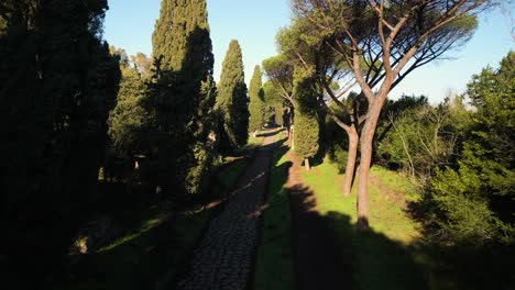 Aerial-Drone-Shot-Above-Cobblestoned-Road,-Appian-Way-in-Rome,-Italy