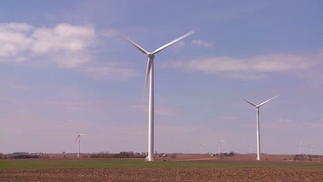 giant windmills in the distance generate power behind farms in the american midwest 5