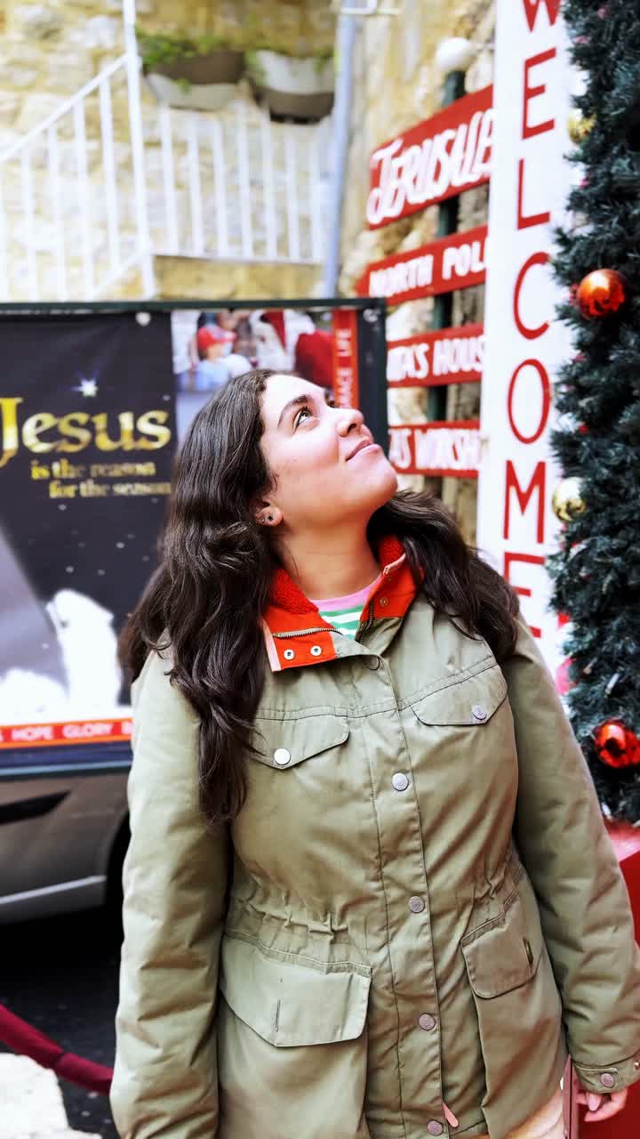 Young Woman Admiring Christmas Decorations in Old City Jerusalem
