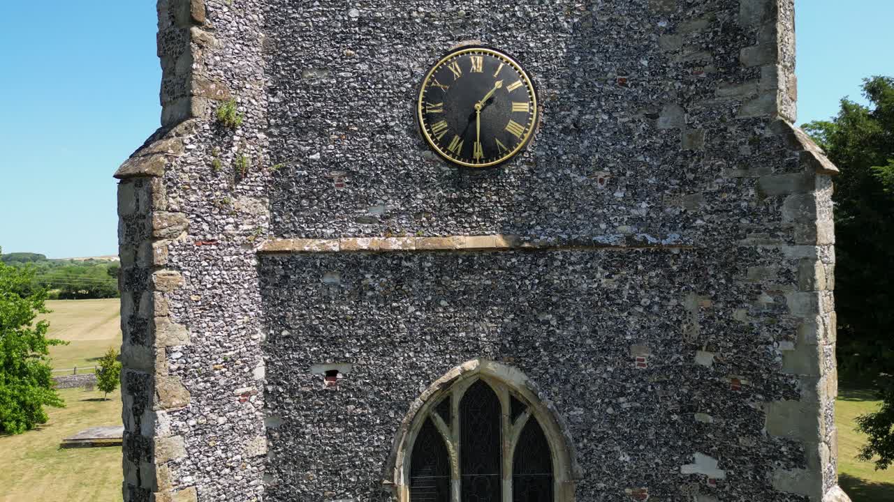 A crawling boom-shot of the tower of St Mary's church in Chartham, showing one of the large windows and clock