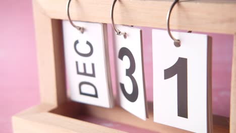 december 31st: new year's eve countdown on wooden calendar