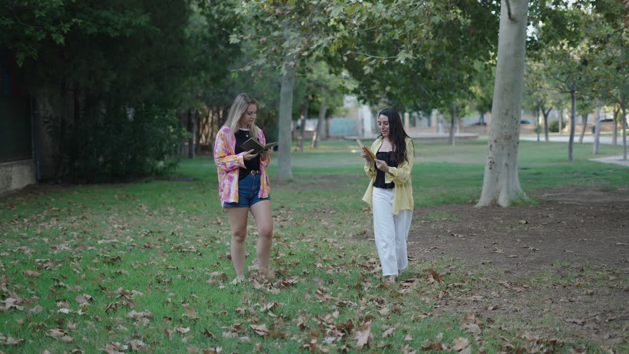 Two friends reading in a park