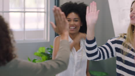 happy business people meeting in boardroom celebrating successful project diverse team of women high five enjoying success clapping in office workplace presentation