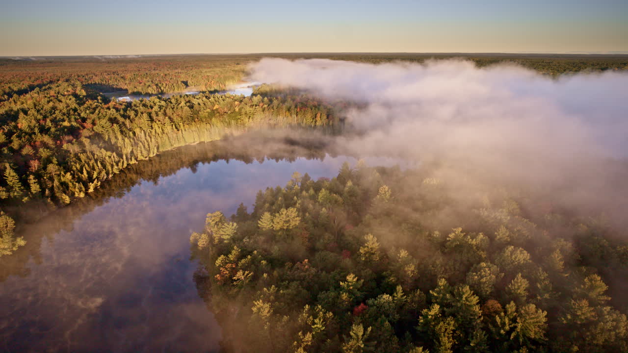 Drone captures rising mist above water at first light