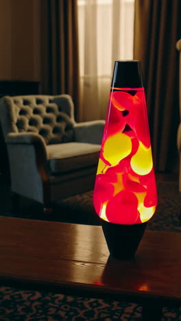 a colorful lava lamp on a wooden table in a cozy room