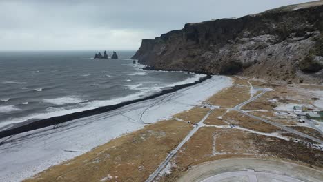 An-aerial-view-shows-the-Reynisdrangar-Sea-cresting-on-Vik-Iceland