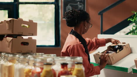 merchant organizing fruits and veggies in crates on shelves