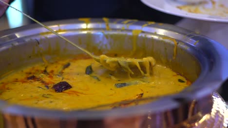 he mixing dal curry in closeup view