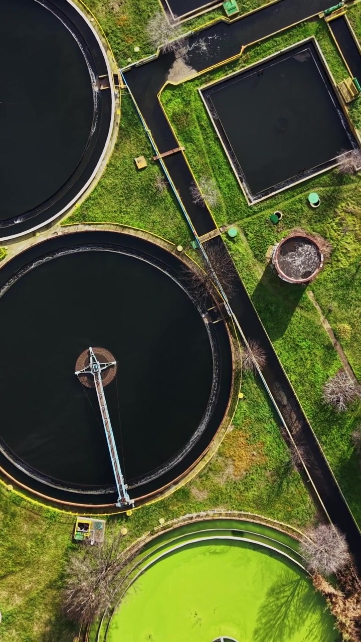 Water treatment facility with large circular tanks seen from above
