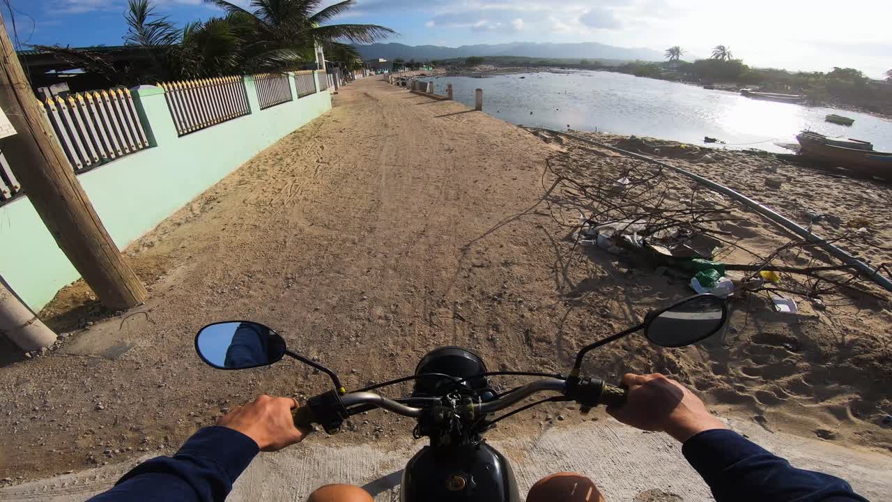 POV of young man riding motorcycle near very polluted roadside in Vietnam