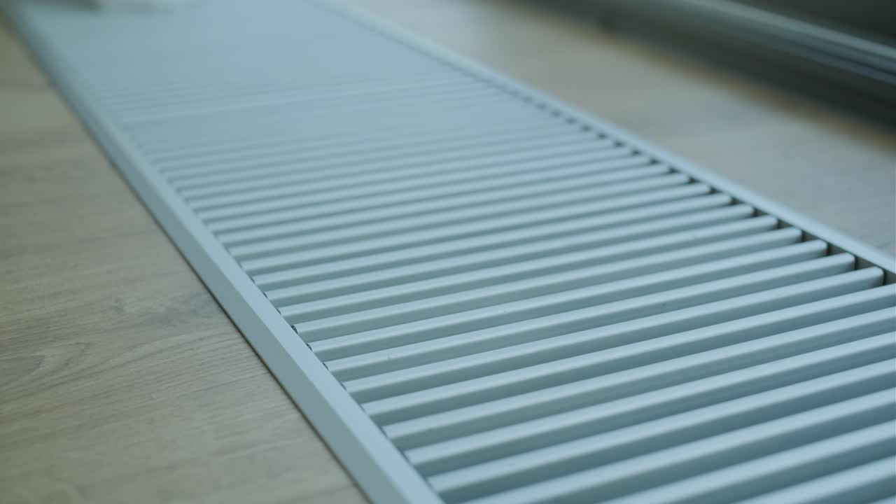 Close-up of an air vent on a wood floor