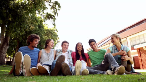 students sitting outside talking together