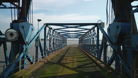 Rückwärtsfahren-Aus-Einer-Verrosteten-Brücke-Und-Unter-Einem-Verlassenen-Kran-Auf-Verlassenem-Dockland-In-Fleetwood-Docks,-Lancashire,-Großbritannien