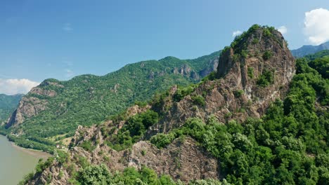 verdant cozia mountains under blue skies with the prominent pietrele rosiei peak