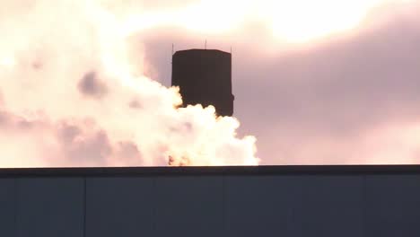 smoke stack emission at sunset