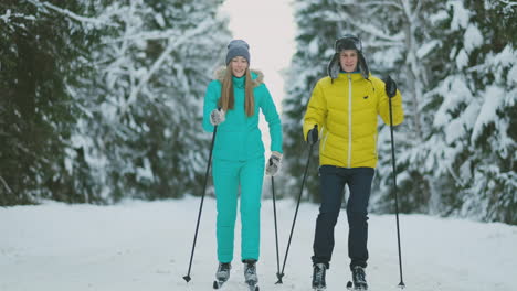 A-married-couple-is-skiing-in-the-forest-practicing-a-healthy-lifestyle.-Slow-motion