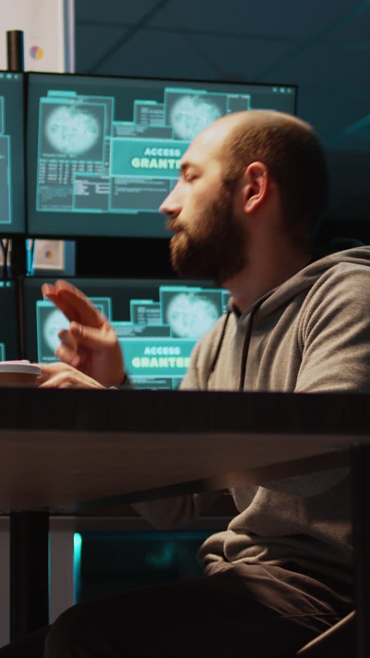 Vertical video: Cyber scammer feeling happy about hacking security system