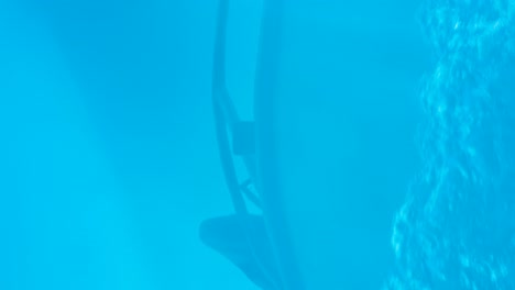 A-boat-reflection-in-the-deep-blue-and-turquoise-ocean-water-with-white-wash-wake-spraying-up-from-the-bow-of-motorboat