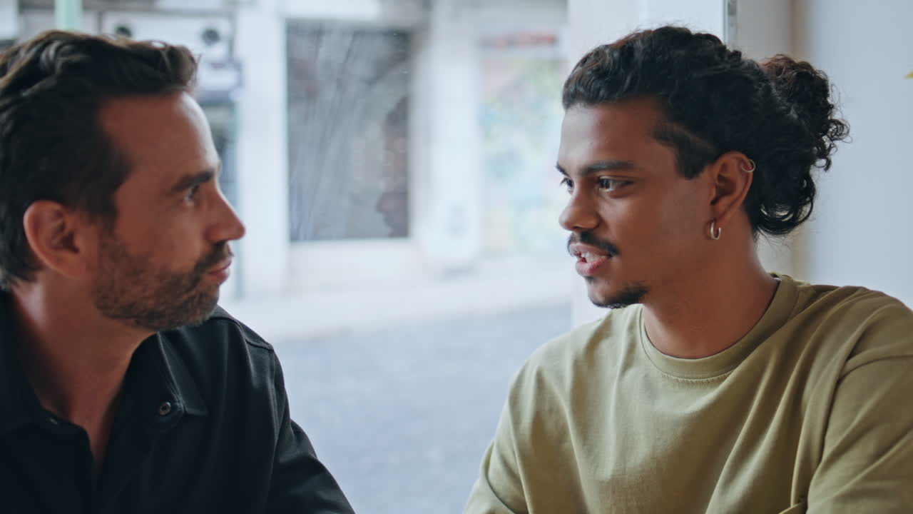 Men having friendly conversation at weekend meeting at pub closeup. Guys friends