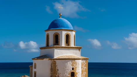 white church with blue dome by the sea