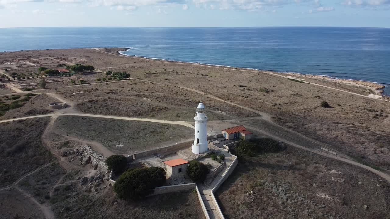 Rising aerial view of the Odeom Paphos lighthouse, a popular landmark in Cyprus, Greece.