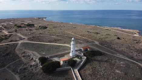 rising aerial view of the odeom paphos lighthouse, a popular landmark in cyprus, greece.