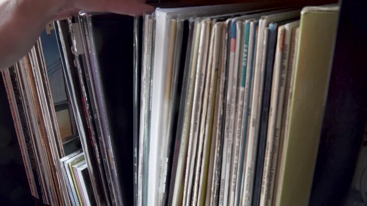 Hand looking for a vinyl in his collection