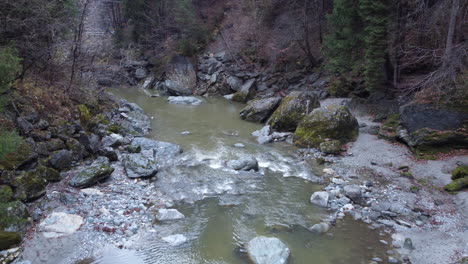 mountain river in forest - aerial dolly forward, drone view, fall, day