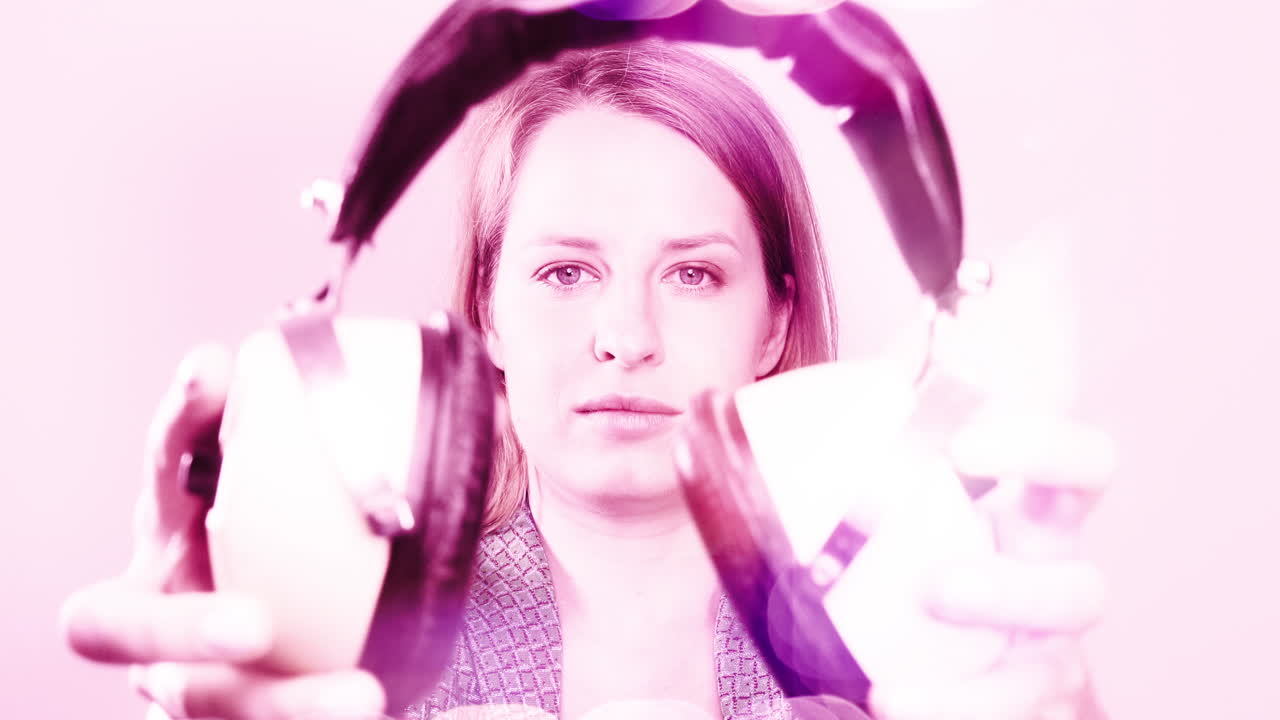 cool female dancer with changing retro headphones to listen to music