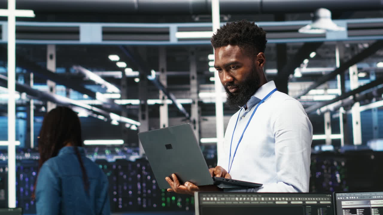 Happy data center admin uses node tree programming on laptop