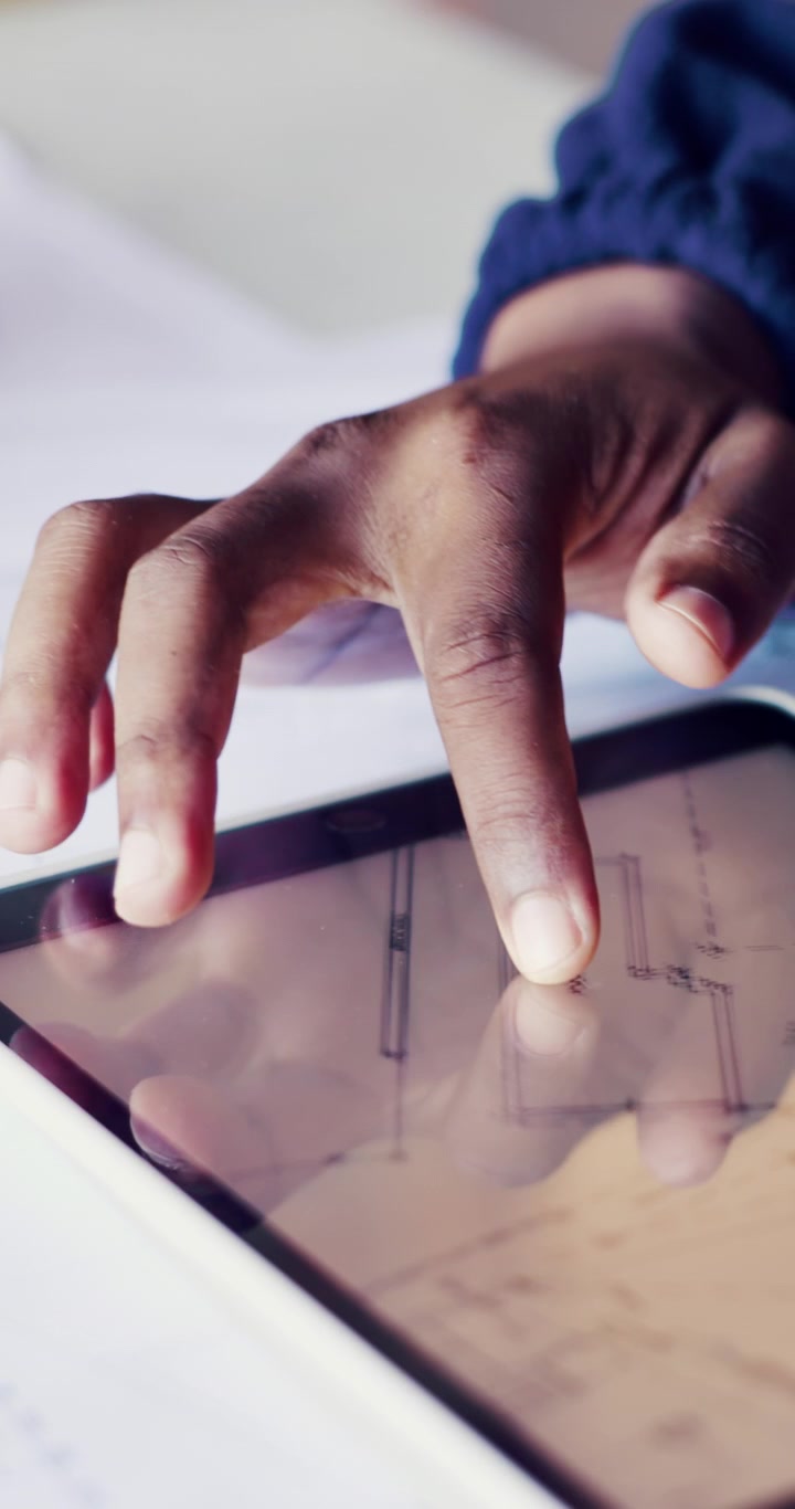 Architecte examinant un plan d'étage sur tablette numérique