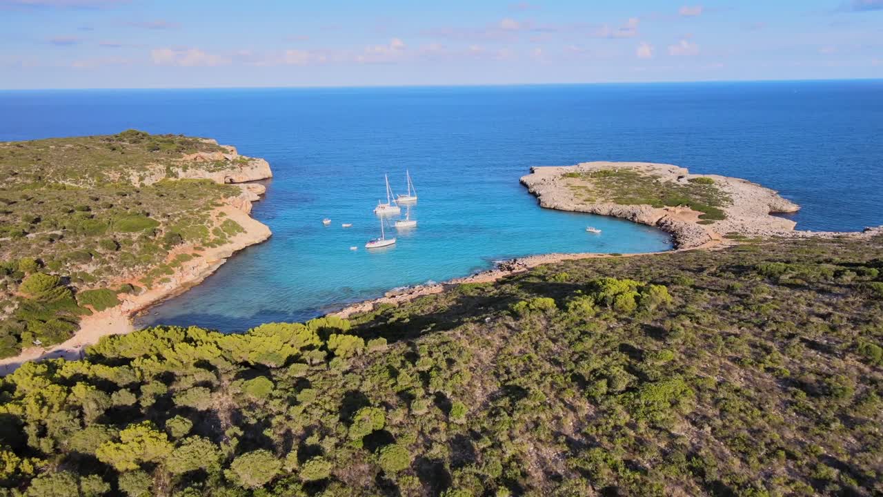 Explore the serene beauty of Cala Varques in Porto Cristo, Majorca. Enjoy breathtaking views of turquoise waters and lush greenery surrounding the peaceful bay.