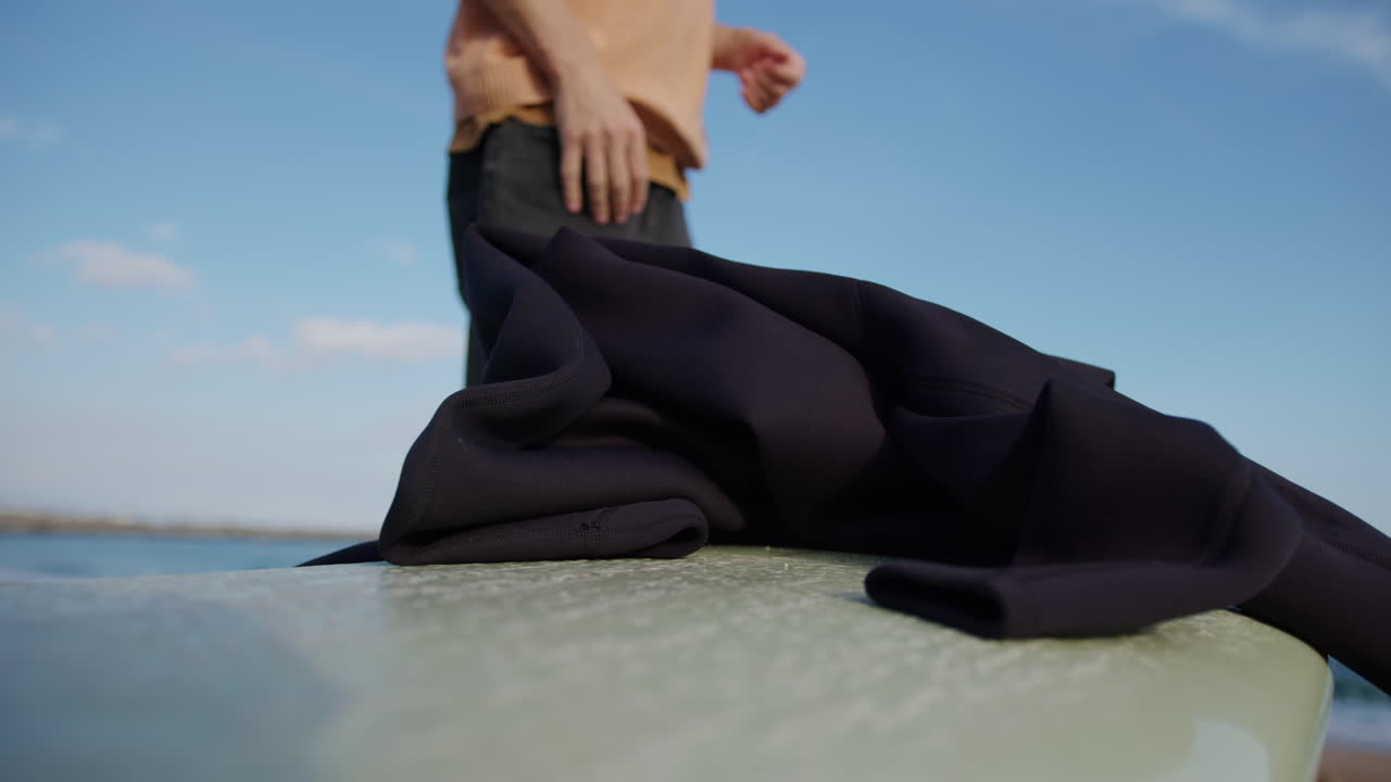 Surfer man walking to the beach at sunset preparing for surfing training and search for waves in Barcelona, spain, water, ocean exercise in sea with board, athletic male holiday or travel in vacation