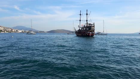 tour ship full of tourists sailing in the bay harbor, visiting attraction destinations in the coastal city, exploring saranda wonders