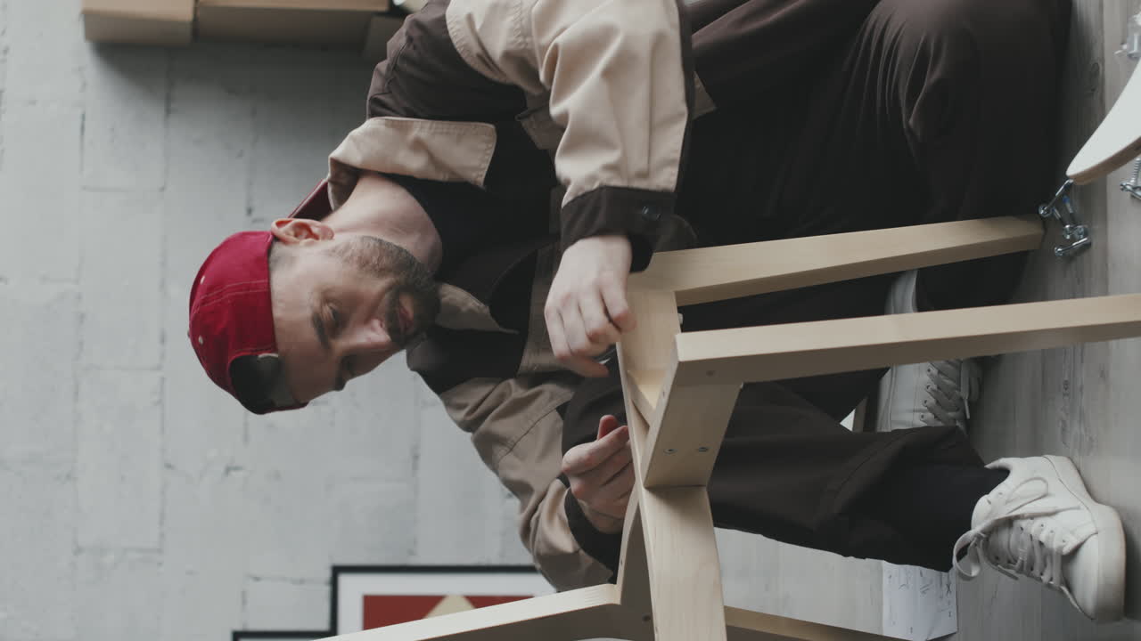 Man Assembling Wooden Chair Indoors