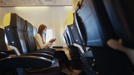 woman using phone on airplane