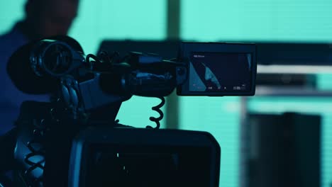 close up detail video of the camera filming recording the face of a suspect offender perpetrator or close up detail video of the camera filming recording the face of a suspect offender perpetrator or prisoner talking to a detective policeman on the background true crime documentary creative
