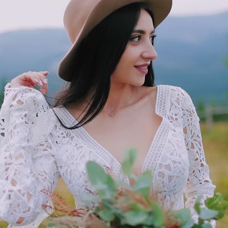. beautiful stylish bride. young bride posing on background of mountains