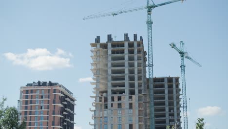 high-rise building under construction with cranes