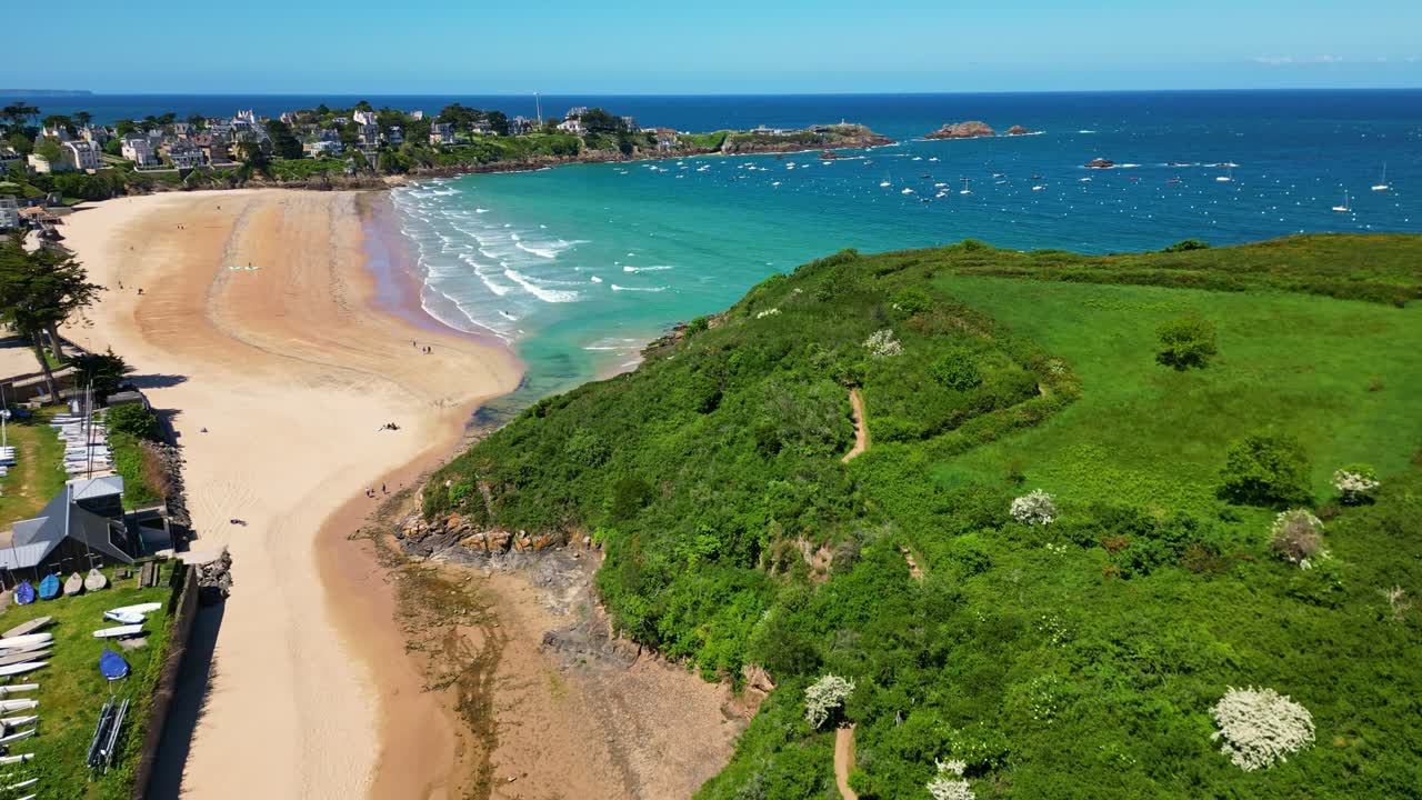 Picturesque Saint-Lunaire beach, golden sand, turquoise water, and charming coastal town in Brittany, France, Ideal for travel or summer promotion. Aerial backward