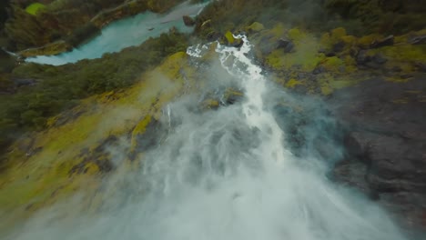 fpv drone diving down a waterfall
