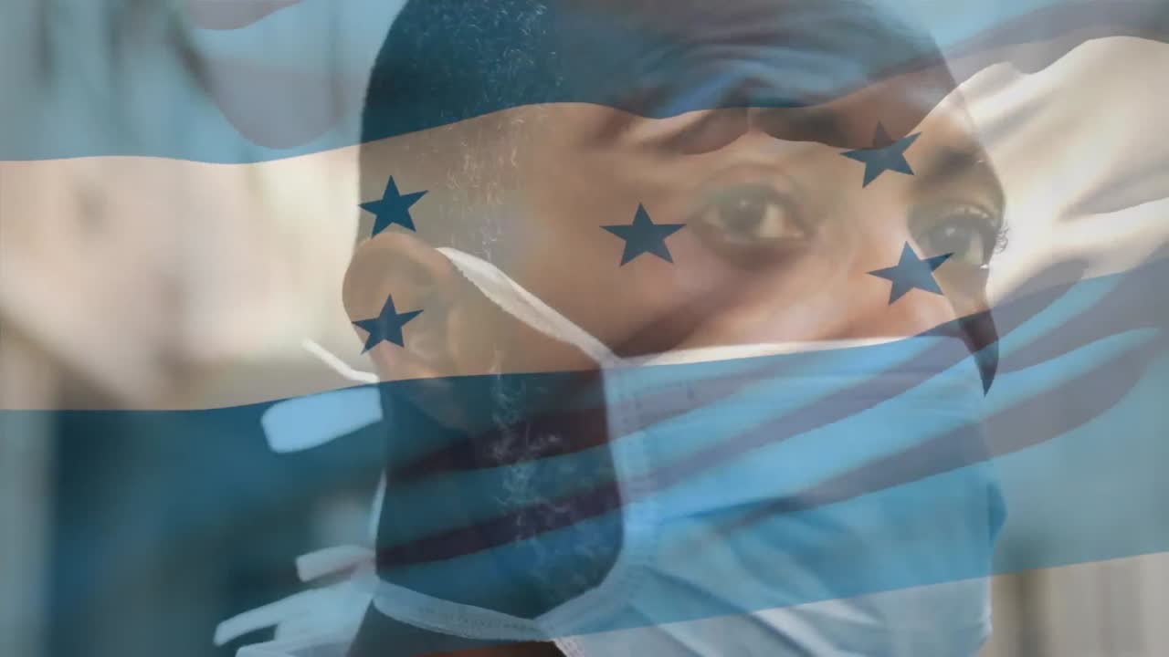 코로나19 전염병 기간 동안 마스크를 쓰고 있는 한 남자가 온두라스 국기를 흔들고 있는 애니메이션