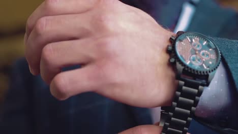 young businessman wears a wristwatch