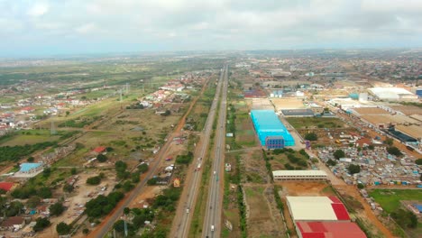moving aerial shot over african industrial road in ghana