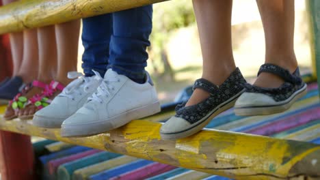 kids standing on a wooden pole 4k