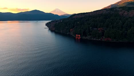 hakone shrine at sunset, with its iconic torii gate set against the stunning backdrop of mount fuji.
