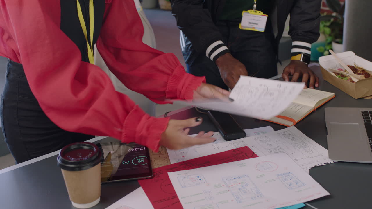 jóvenes ingenieros desarrollando aplicaciones de software compartiendo ideas diversos estudiantes diseñando aplicaciones móviles lluvia de ideas solución de interfaz de diseño utilizando dibujos de diseño reunión en la oficina