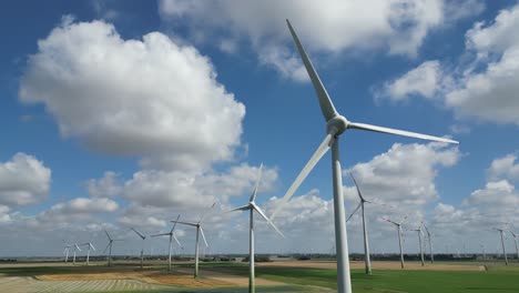 rotating shot revealing a whole group of wind turbines at a wind farm