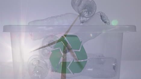 animación de un cartel de reciclaje verde sobre una caja con botellas de plástico y una turbina eólica