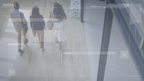 animation of data processing against overhead view of diverse colleagues walking at office